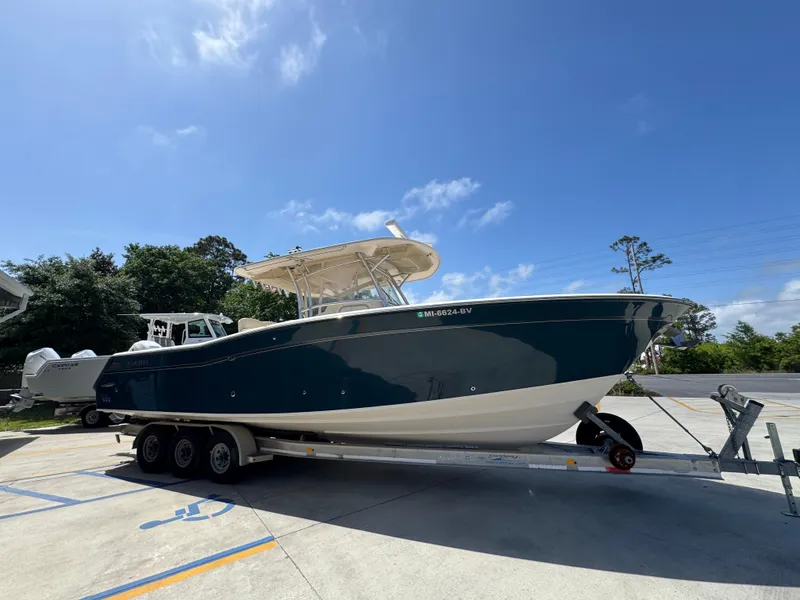 Slide: The Image of 2014 Grady-White Canyon 336 boat on trailer under clear blue sky. - 12