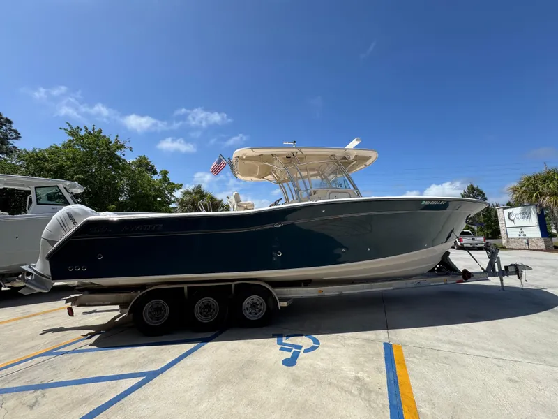 Slide: The Image of 2014 Grady-White Canyon 336 boat on trailer under clear blue sky. - 14