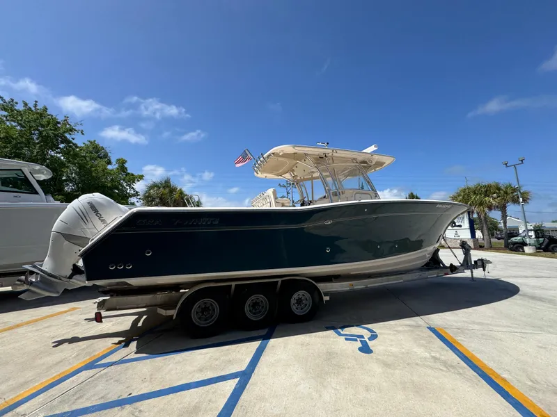 Slide: The Image of 2014 Grady-White Canyon 336 boat on trailer under clear blue sky. - 15