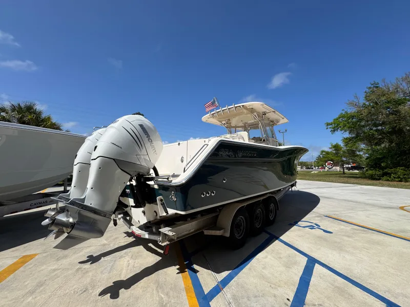 Slide: The Image of 2014 Grady-White Canyon 336 boat on trailer, dual outboard engines, sunny day. - 18