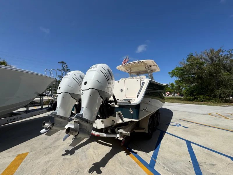 Slide: The Image of 2014 Grady-White Canyon 336 boat with dual outboard engines on a trailer. - 19