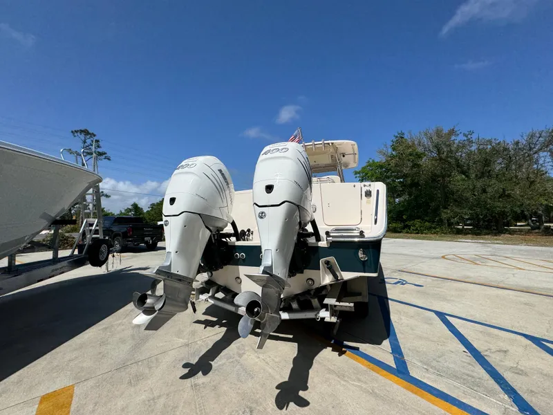Slide: The Image of 2014 Grady-White Canyon 336 boat with twin outboard motors in a parking area. - 20