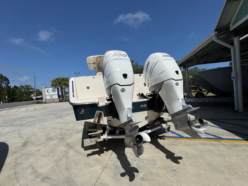 Slide: The Image of 2014 Grady-White Canyon 336 boat with twin outboard engines in a parking area. - 22