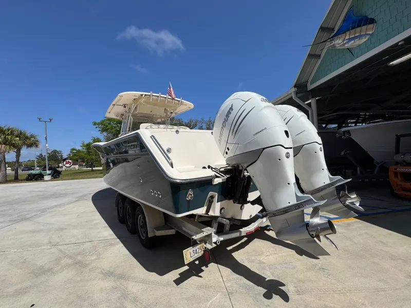 Slide: The Image of 2014 Grady-White Canyon 336 boat with dual outboard engines on a trailer. - 23