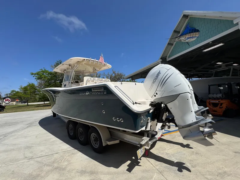Slide: The Image of 2014 Grady-White Canyon 336 boat on trailer, parked outdoors near a building. - 24