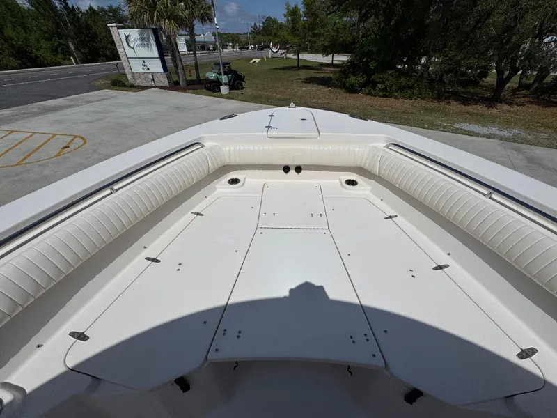 Slide: The Image of 2014 Grady-White Canyon 336 boat deck with cushioned seating and storage compartments. - 26