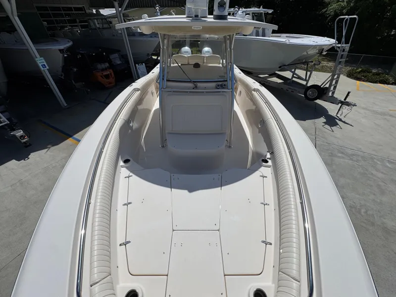 Slide: The Image of 2014 Grady-White Canyon 336 boat, spacious deck, parked in marina. - 27