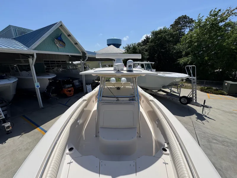 Slide: The Image of 2014 Grady-White Canyon 336 boat docked at a marina under clear blue skies. - 28