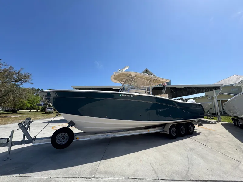 Slide: The Image of 2014 Grady-White Canyon 336 boat on trailer under clear blue sky. - 3