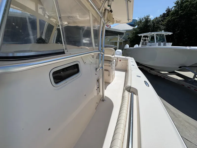 Slide: The Image of 2014 Grady-White Canyon 336 boat, side view, showcasing deck and seating area. - 31