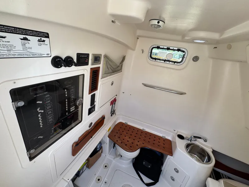 Slide: The Image of 2014 Grady-White Canyon 336 cabin interior with control panel, sink, and window. - 34