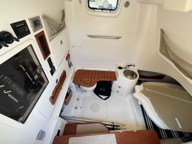 Slide: The Image of 2014 Grady-White Canyon 336 cabin interior with seating, storage, and control panel. - 35