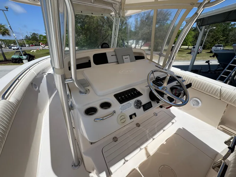 Slide: The Image of 2014 Grady-White Canyon 336 boat cockpit with steering wheel and control panel. - 38