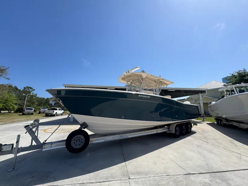 Slide: The Image of 2014 Grady-White Canyon 336 boat on trailer under clear blue sky. - 4
