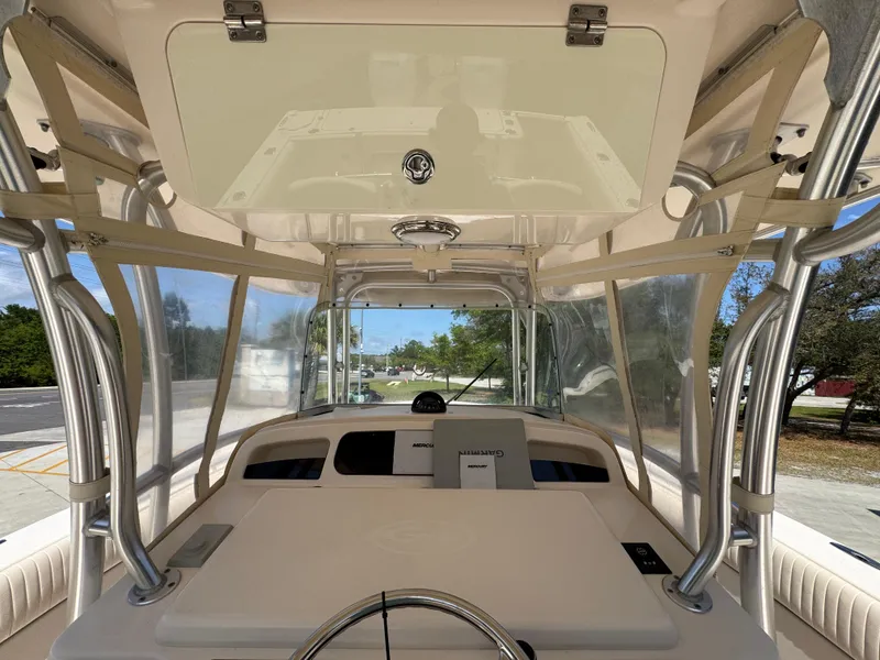 Slide: The Image of 2014 Grady-White Canyon 336 boat helm with steering wheel and navigation equipment. - 40