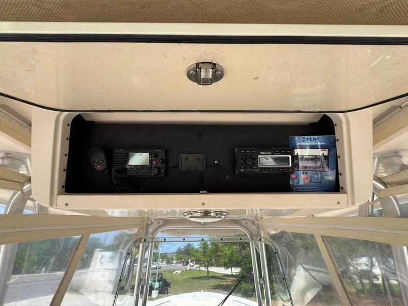 Slide: The Image of 2014 Grady-White Canyon 336 boat console with radio equipment and storage compartment. - 41
