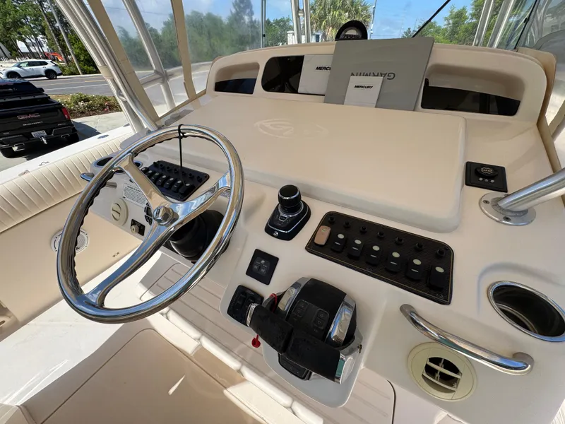 Slide: The Image of Helm of 2014 Grady-White Canyon 336 boat with steering wheel and control panel. - 42