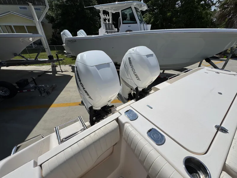 Slide: The Image of 2014 Grady-White Canyon 336 boat with twin outboard motors in a marina setting. - 49