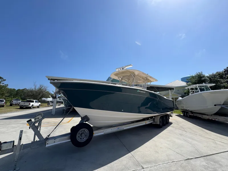 Slide: The Image of 2014 Grady-White Canyon 336 boat on trailer under clear blue sky. - 5