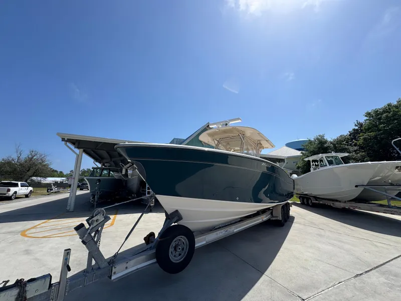 Slide: The Image of 2014 Grady-White Canyon 336 boat on trailer under clear blue sky. - 6