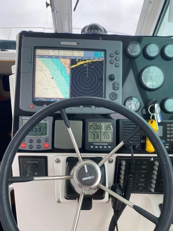 Slide: The Image of 2007 Albin 28 Tournament Express dashboard with navigation and control instruments. - 13