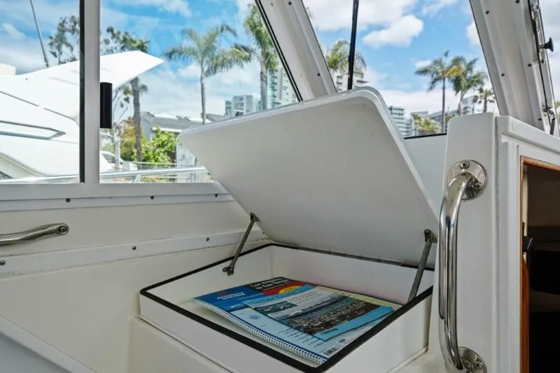 Slide: The Image of 2007 Albin 28 Tournament Express interior with open storage compartment and manuals. - 14