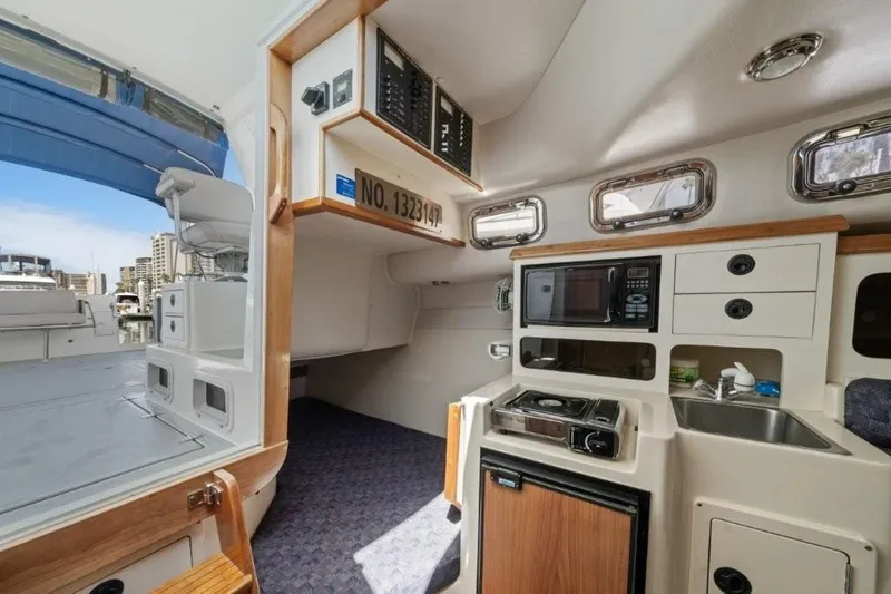 Slide: The Image of Interior of 2007 Albin 28 Tournament Express boat with kitchenette and seating area. - 20