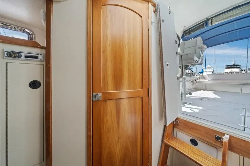 Slide: The Image of Interior view of 2007 Albin 28 Tournament Express with wooden door and outdoor deck access. - 21