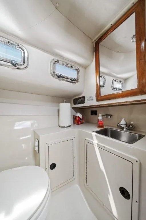 Slide: The Image of 2007 Albin 28 Tournament Express bathroom with sink, mirror, and portholes. - 22