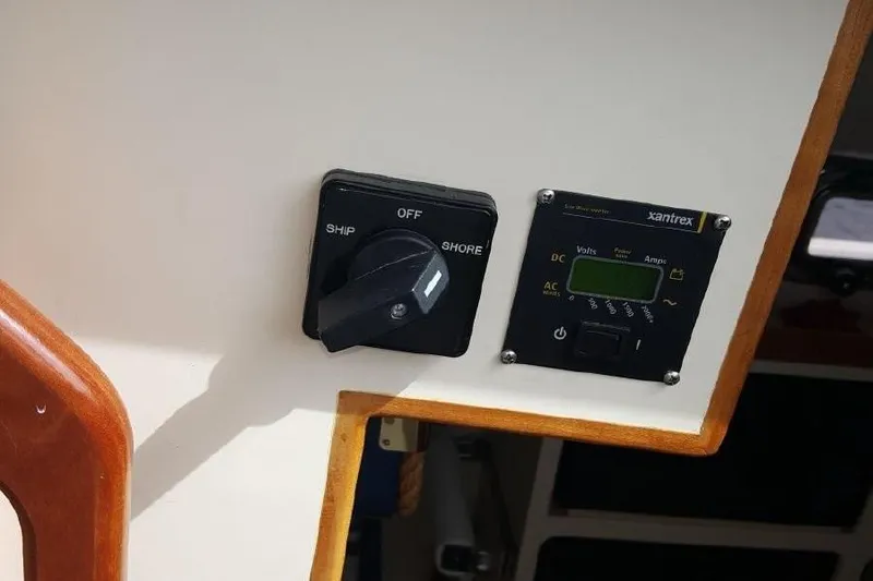 Slide: The Image of Control panel on a 2007 Albin 28 Tournament Express boat, featuring ship and shore switches. - 23