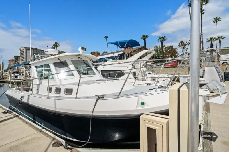Slide: The Image of 2007 Albin 28 Tournament Express boat docked at a marina under a clear blue sky. - 3