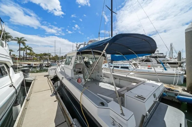Slide: The Image of 2007 Albin 28 Tournament Express docked at a marina under a clear blue sky. - 4