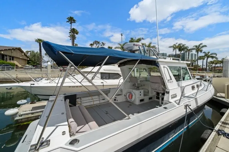 Slide: The Image of 2007 Albin 28 Tournament Express boat docked in marina, blue canopy, clear sky. - 5