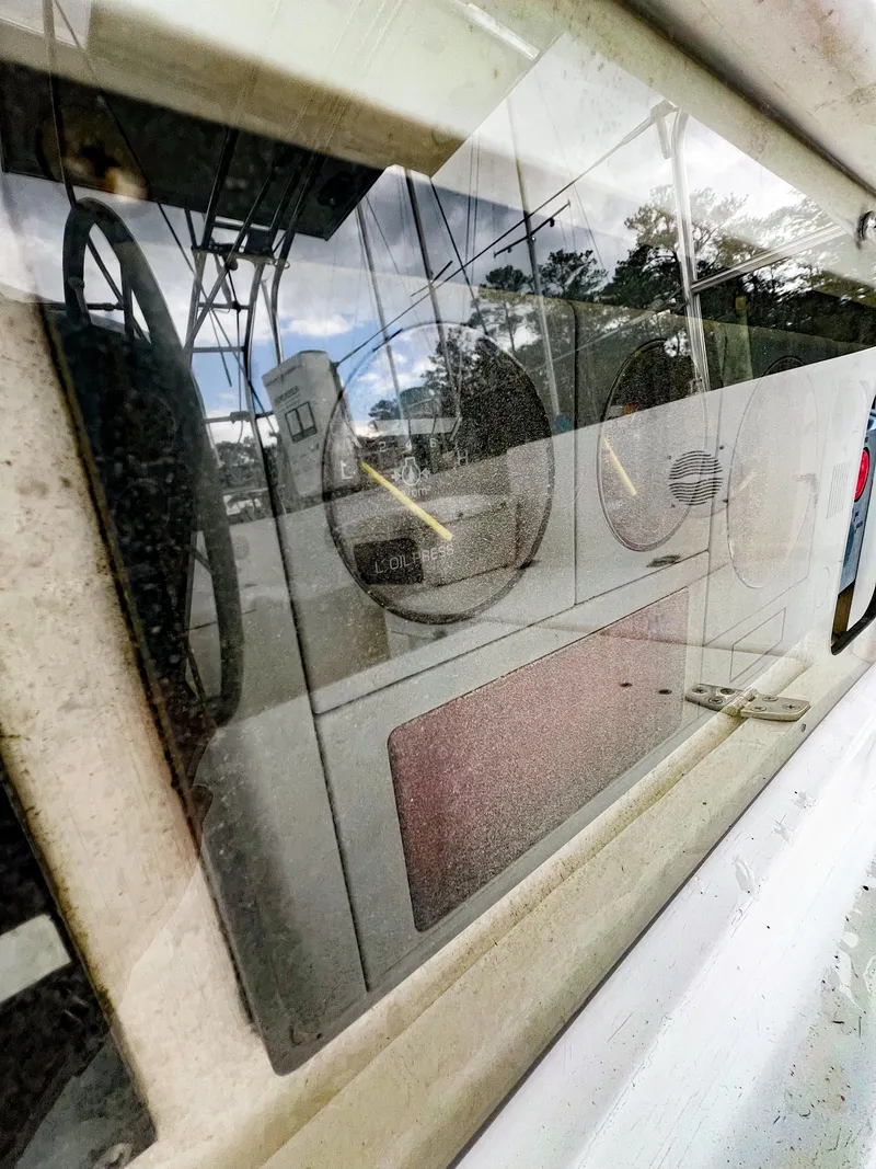 Slide: The Image of Reflection on Saga 43 boat window, showcasing interior gauges, 1998 model. - 15