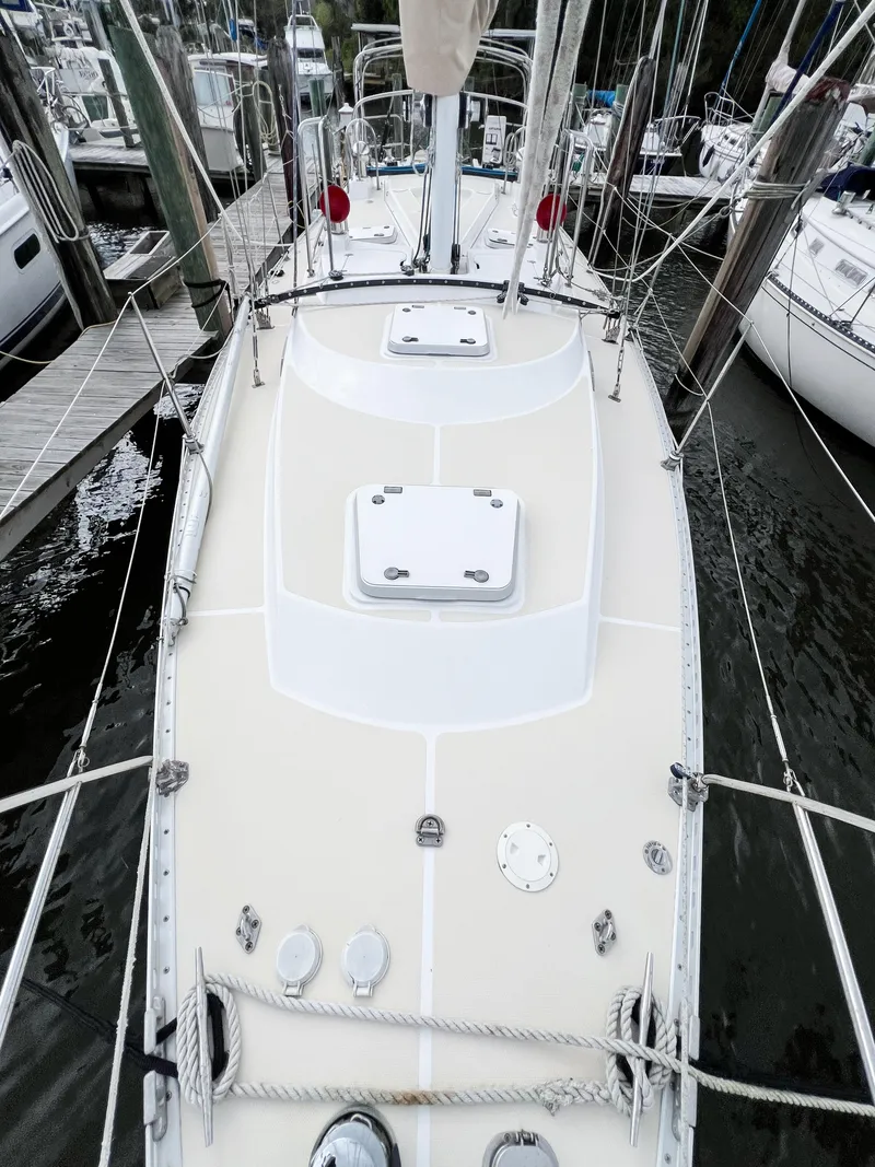 Slide: The Image of 1998 Saga 43 sailboat docked, showcasing deck and rigging details. - 20