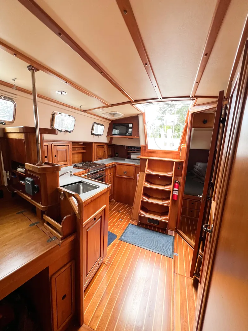 Slide: The Image of Interior of 1998 Saga 43 sailboat with wooden cabinetry and flooring. - 26