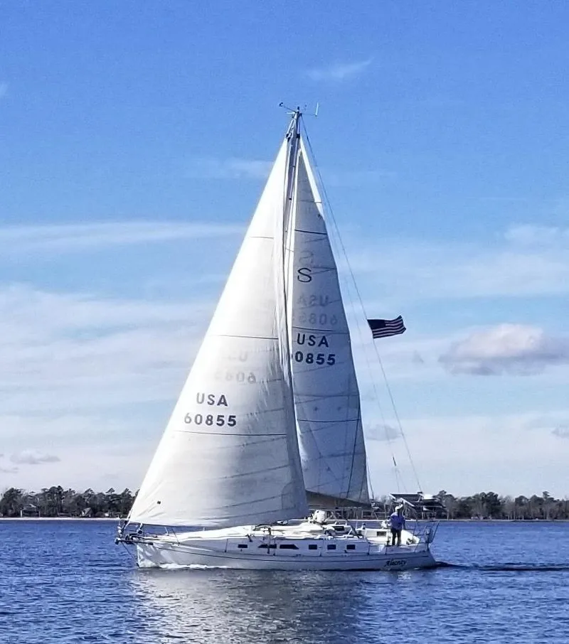Slide: The Image of Sailing yacht Saga 43, 1998 model, gliding on calm waters under clear blue skies. - 3