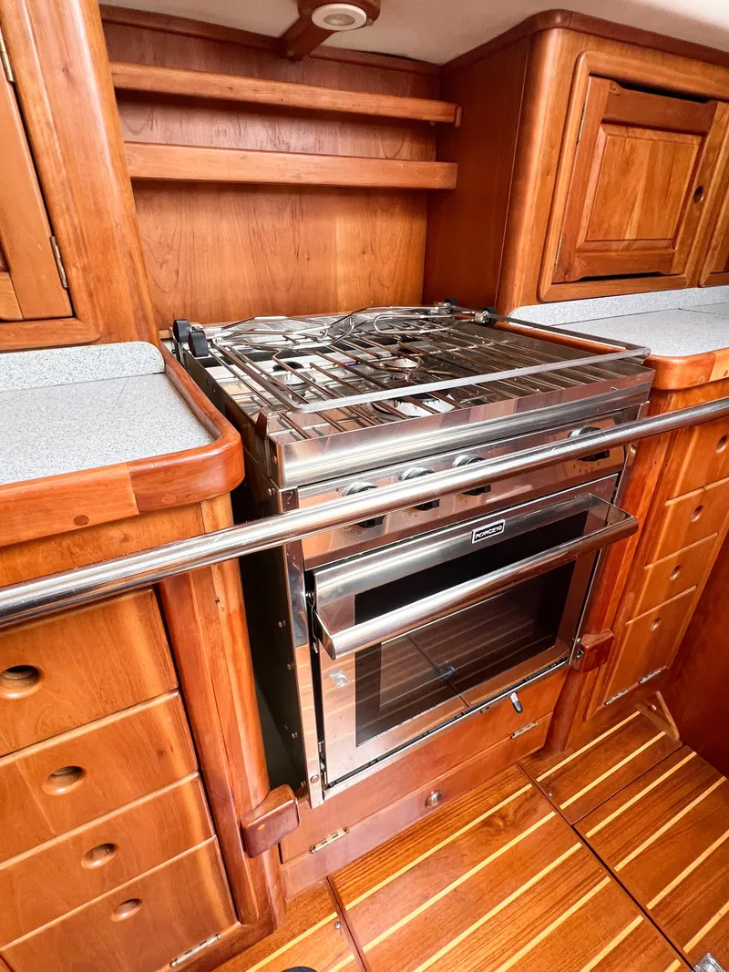 Slide: The Image of Wooden kitchen interior of 1998 Saga 43 yacht with stainless steel stove and oven. - 31
