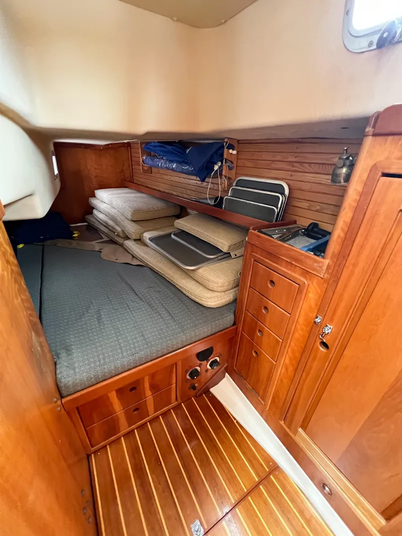 Slide: The Image of Cozy cabin interior of 1998 Saga 43 sailboat with wooden furnishings and bedding. - 37