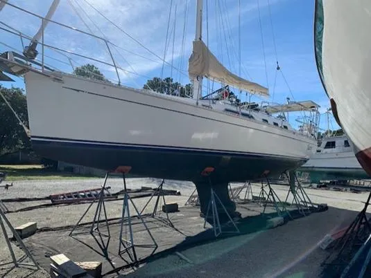 Slide: The Image of Sailboat on stands, Saga 43 model, 1998, in a boatyard under clear blue sky. - 4