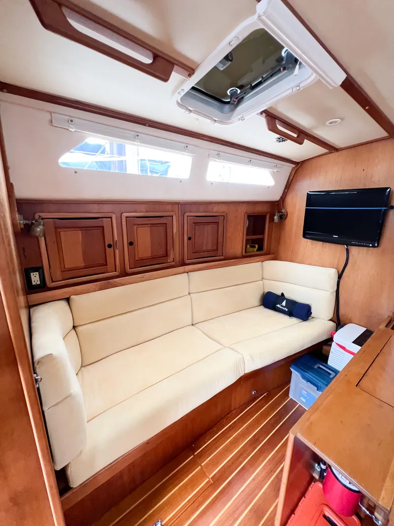 Slide: The Image of Interior of 1998 Saga 43 yacht with beige seating and wooden cabinetry. - 44