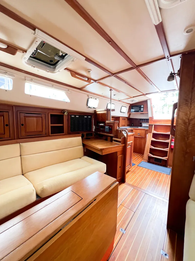 Slide: The Image of Interior of 1998 Saga 43 sailboat with wooden furnishings and cozy seating area. - 46