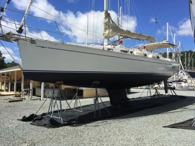 Slide: The Image of Sailboat Saga 43, 1998 model, on stands in a boatyard under a clear blue sky. - 5