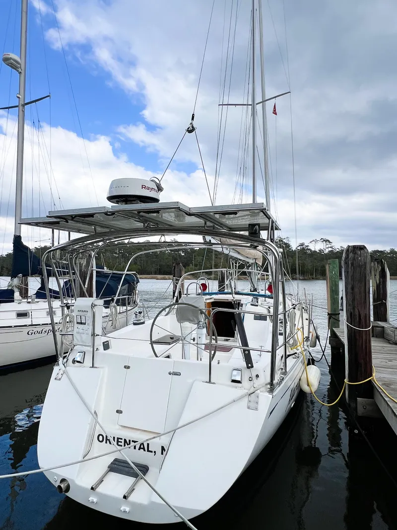 Slide: The Image of Sailboat docked at marina, Saga 43 model, 1998, under cloudy sky. - 7