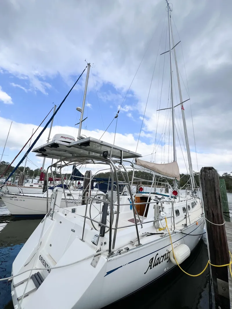 Slide: The Image of Sailboat docked at marina, Saga 43 model, 1998, under cloudy sky. - 8