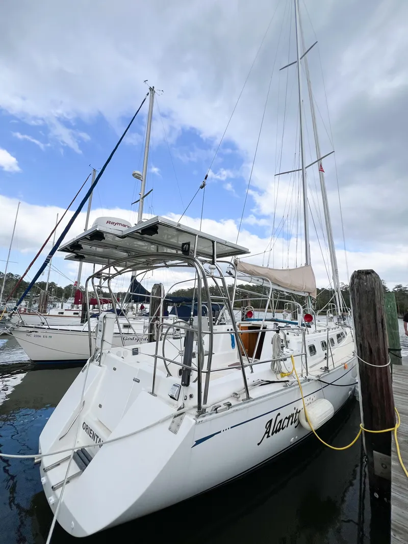 Slide: The Image of 1998 Saga 43 sailboat docked at marina under cloudy sky. - 9