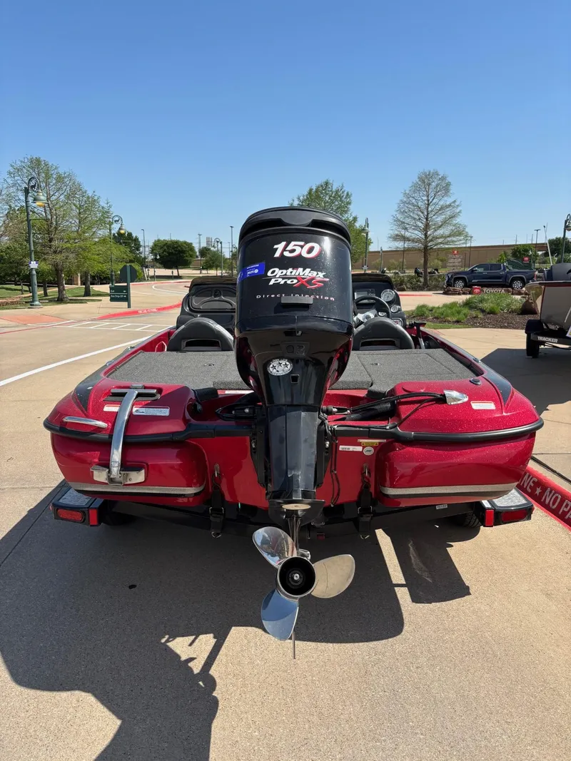Slide: The Image of 2012 Nitro Z7 boat with 150 horsepower outboard motor, parked on a sunny day. - 4