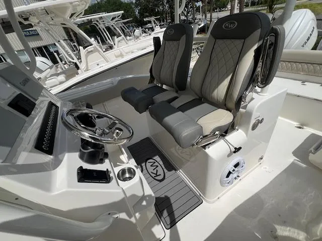 Slide: The Image of 2025 Key West 263 FS boat interior with dual seats and steering console. - 8