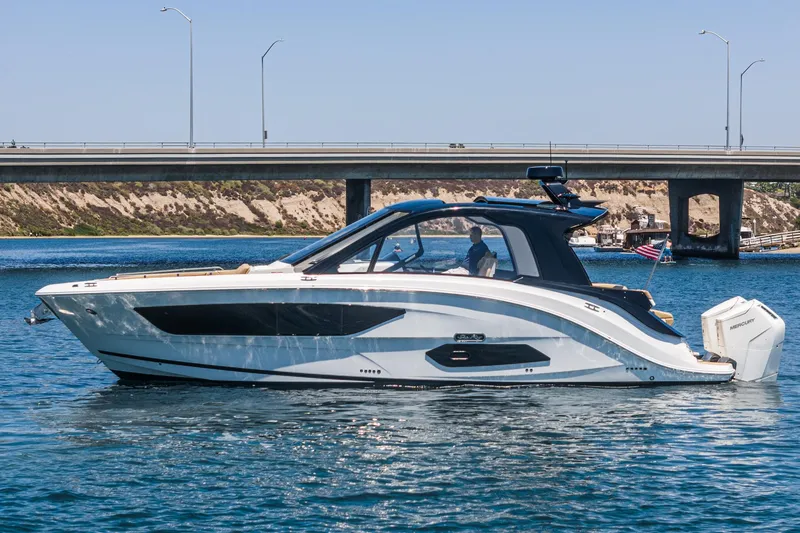 Slide: The Image of 2023 Sea Ray Sundancer 370 OB cruising on a sunny day near a bridge. - 10