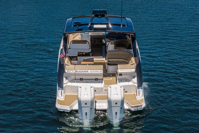 Slide: The Image of 2023 Sea Ray Sundancer 370 OB cruising on water, rear view. - 11